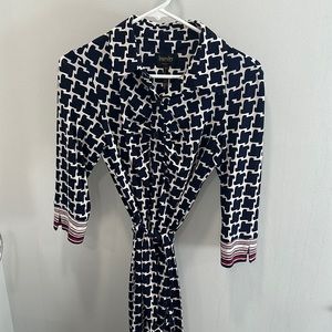 Navy blue geometric tie dress with pink accents.